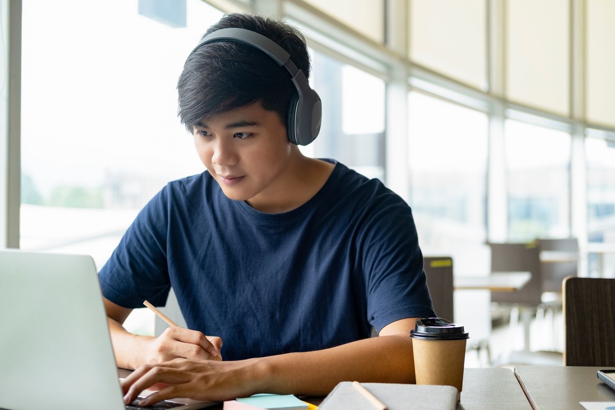 Young College Student Using Computer Laptop Studying